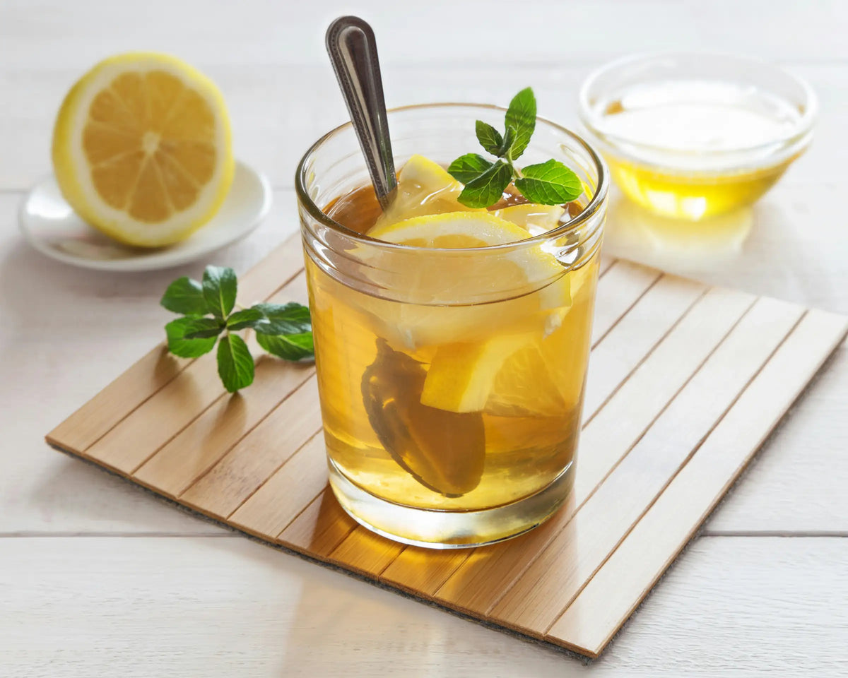 Steaming honey lemon tea with fresh lemon for a soothing, comforting drink
